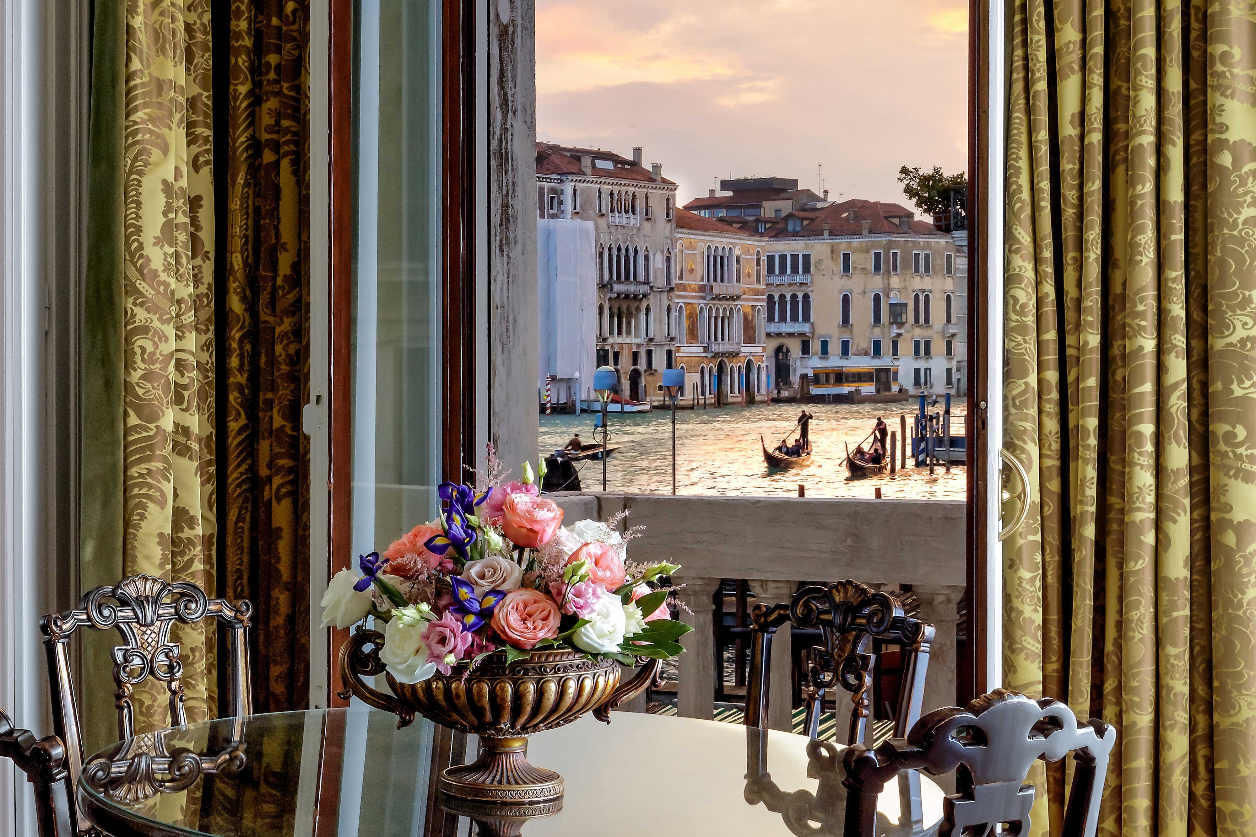 Guest room dining table next to a window overlooking the canal