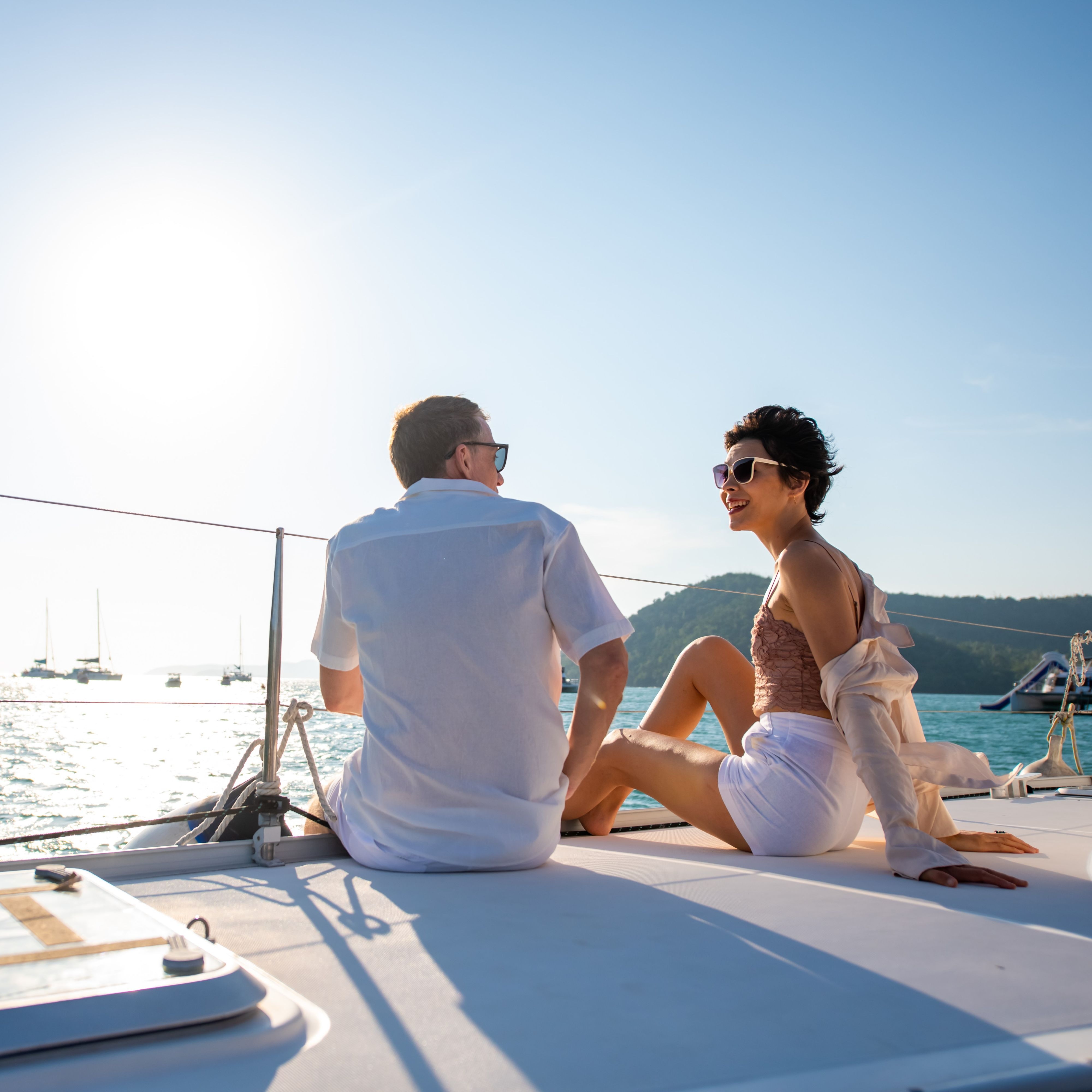 Couple drinking champagne on catamaran