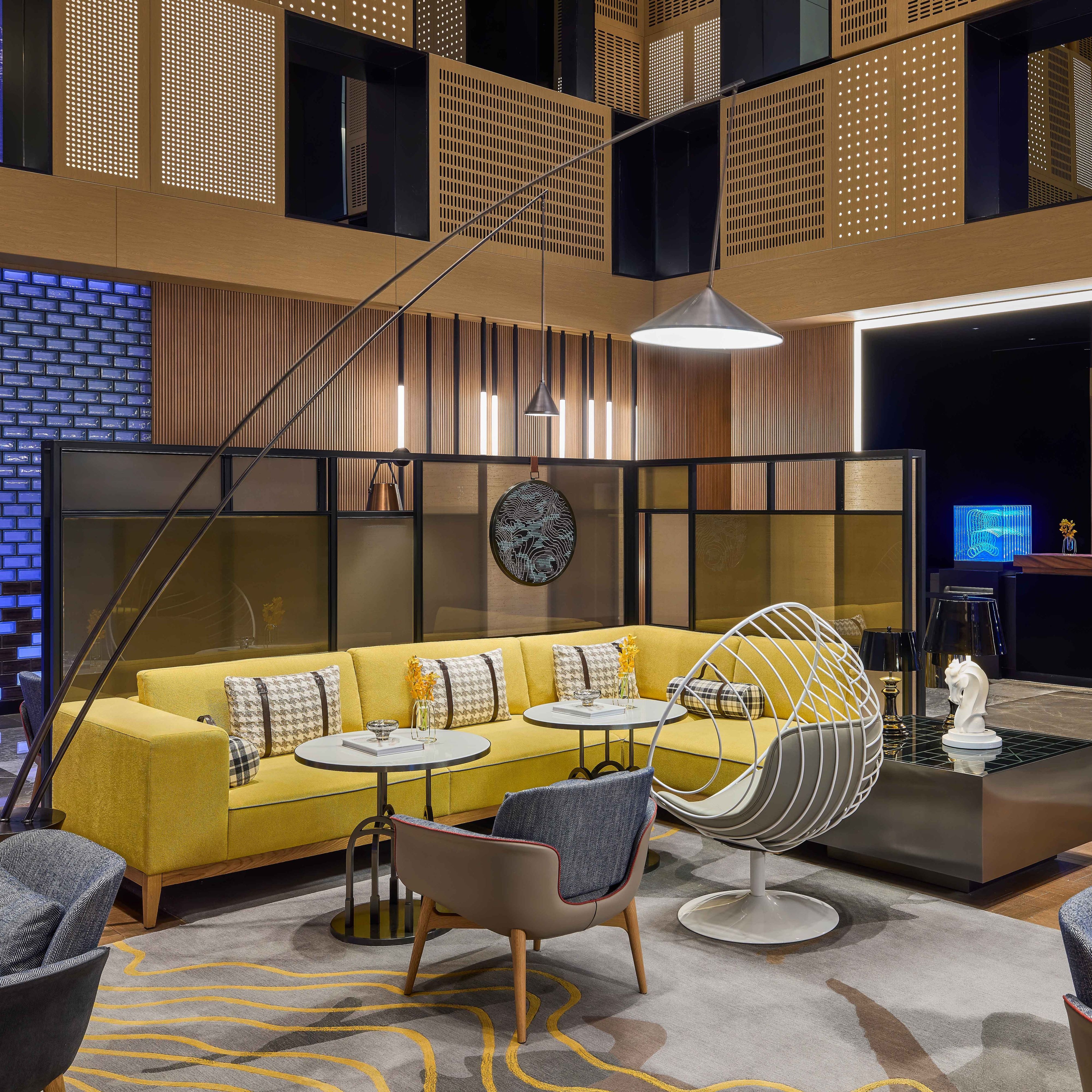 lounge with yellow sofa, tables and chairs