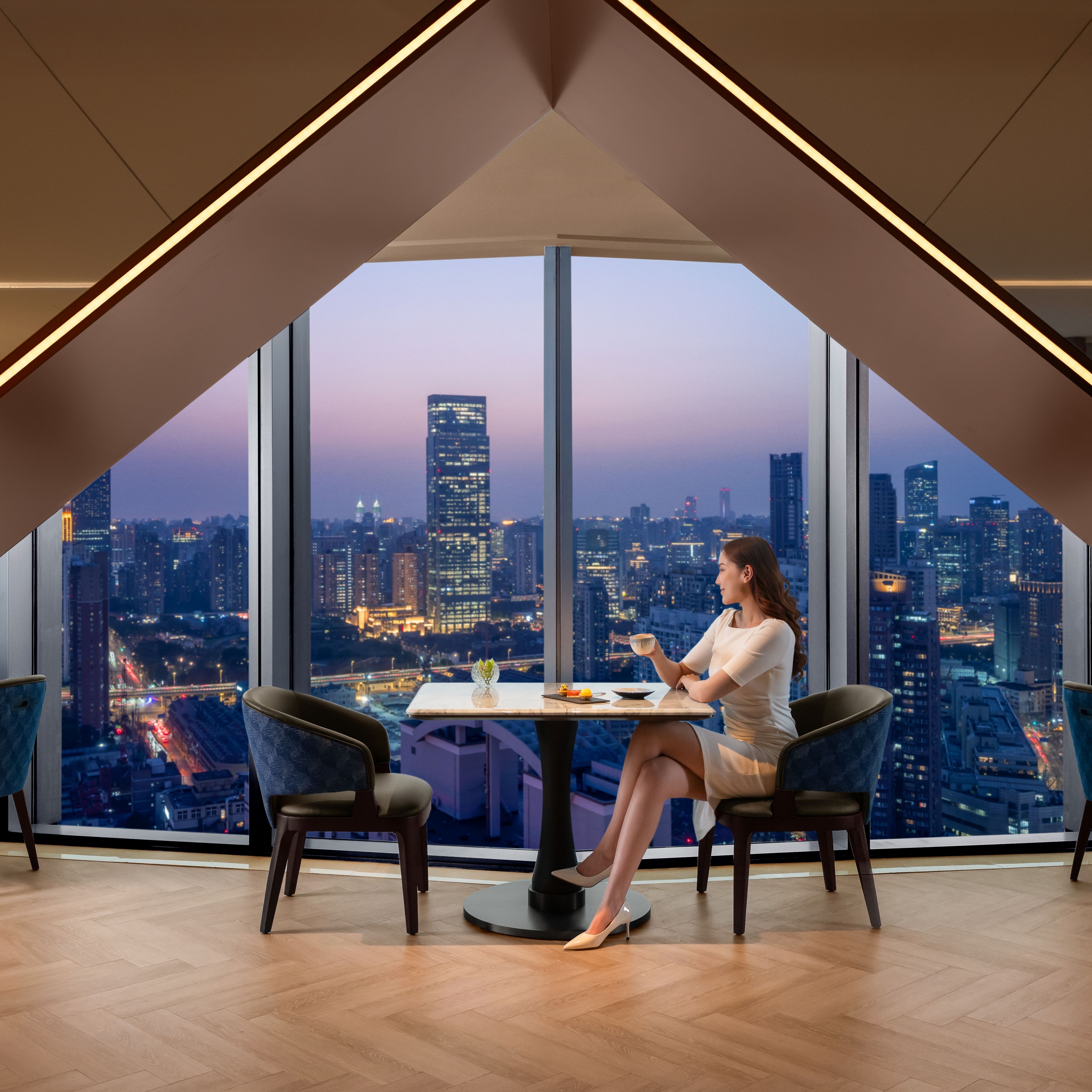 woman sitting in lounge next to windows